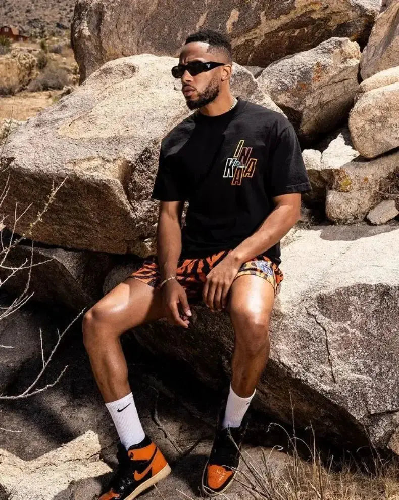 Mens motorcycle shorts with orange-black pattern, quick-dry breathable mesh fabric for gym or beach.