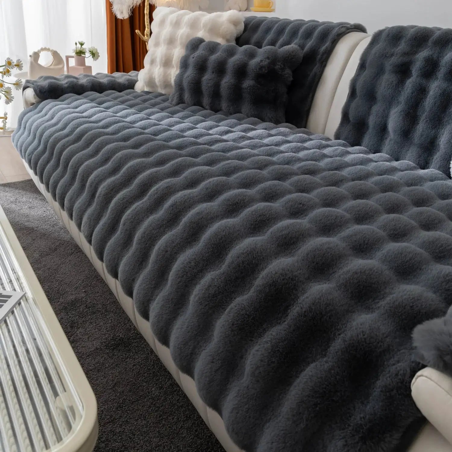 Thick faux rabbit fur sofa slipcover in dark gray on a plush couch with matching cushions