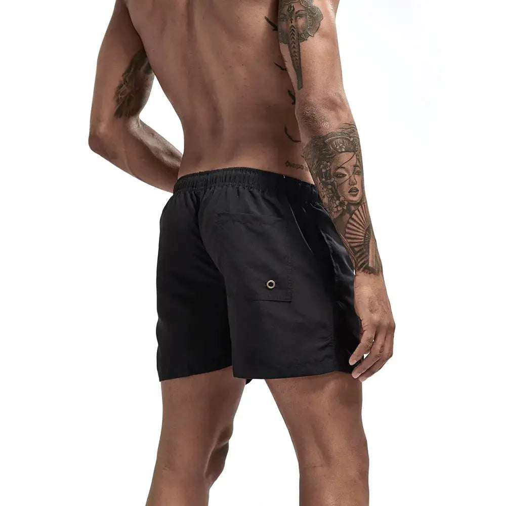 Men's black quick-dry swim trunks with back pocket and metal grommet.