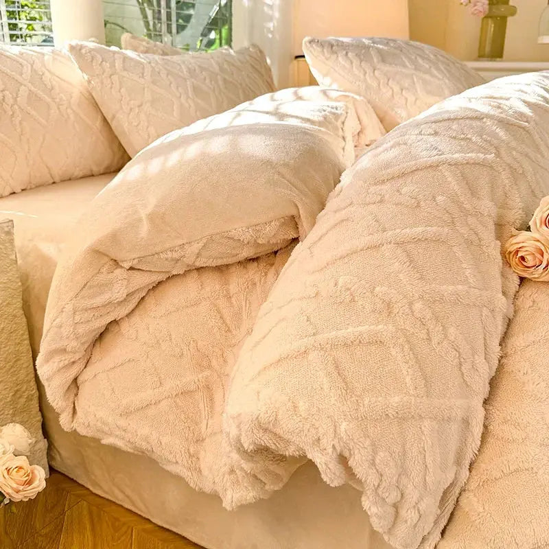 Tafuru Milk Fleece quilt set laid on a cream bed with plush, textured duvet and matching pillows