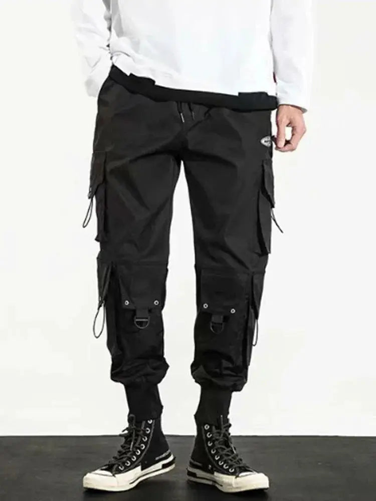 Men's black streetwear cargo pants with multiple pockets and straps, Simples Market.