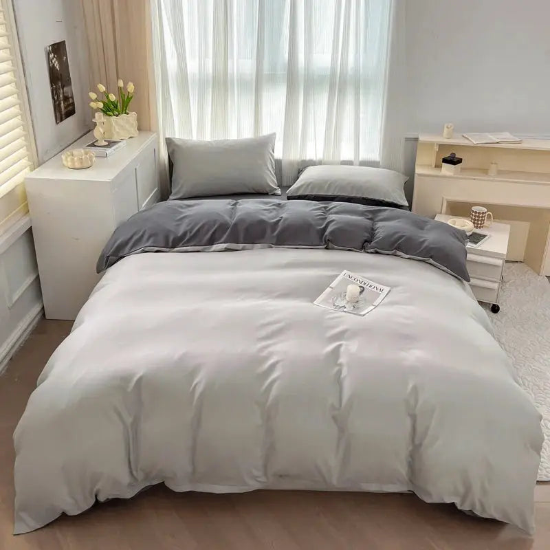 2-side solid color brush fabric bed set, 4 pieces, gray duvet cover and matching gray pillowcases on a white bed