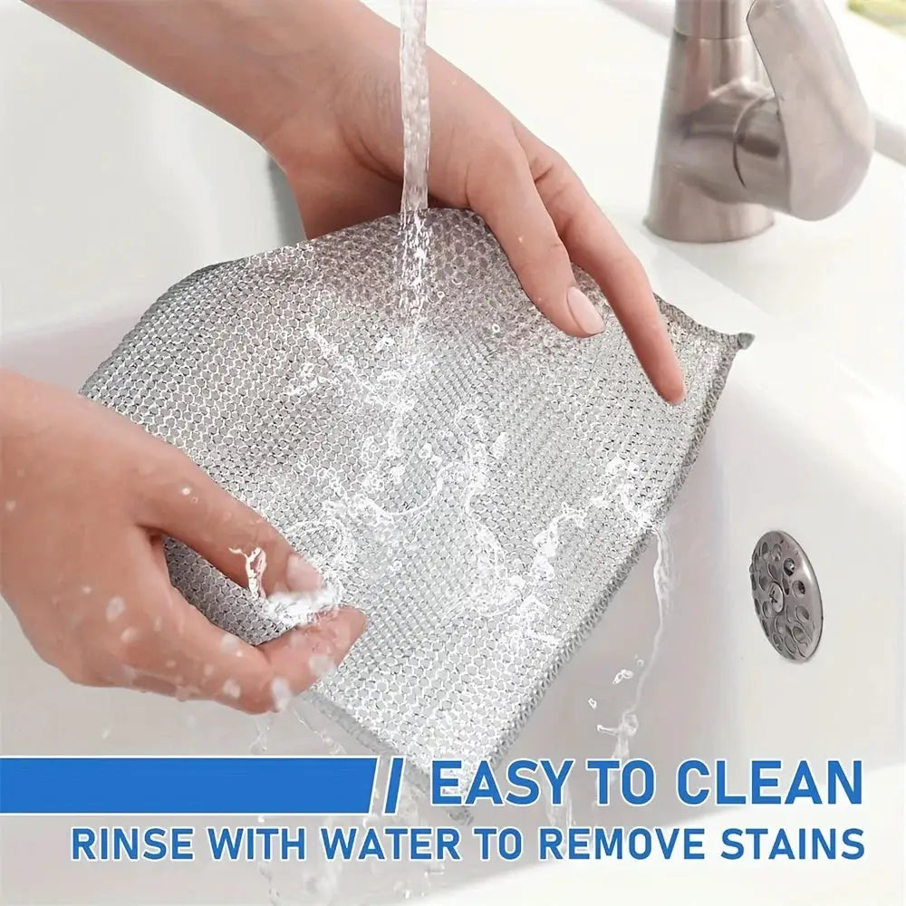 Steel mesh cleaning cloth being rinsed under water; double-layer non-scratch dish rag in silver.