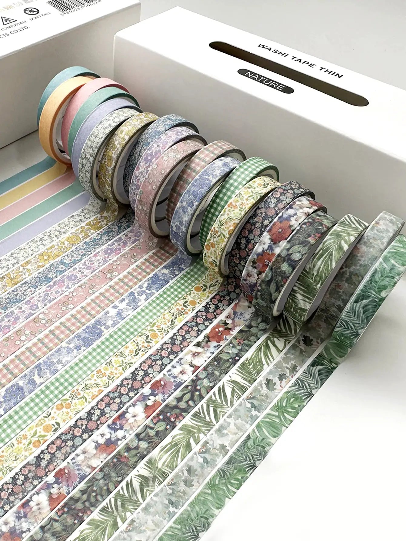 20 rolls of Simples Market washi tape with delicate floral and plant patterns in pastel colors.