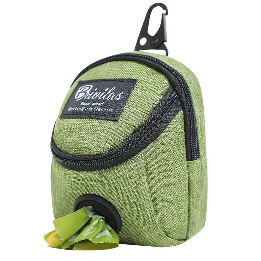 Dog treat pouch by Simples Market in green fabric with zipper, carabiner clip, and poop bag dispenser