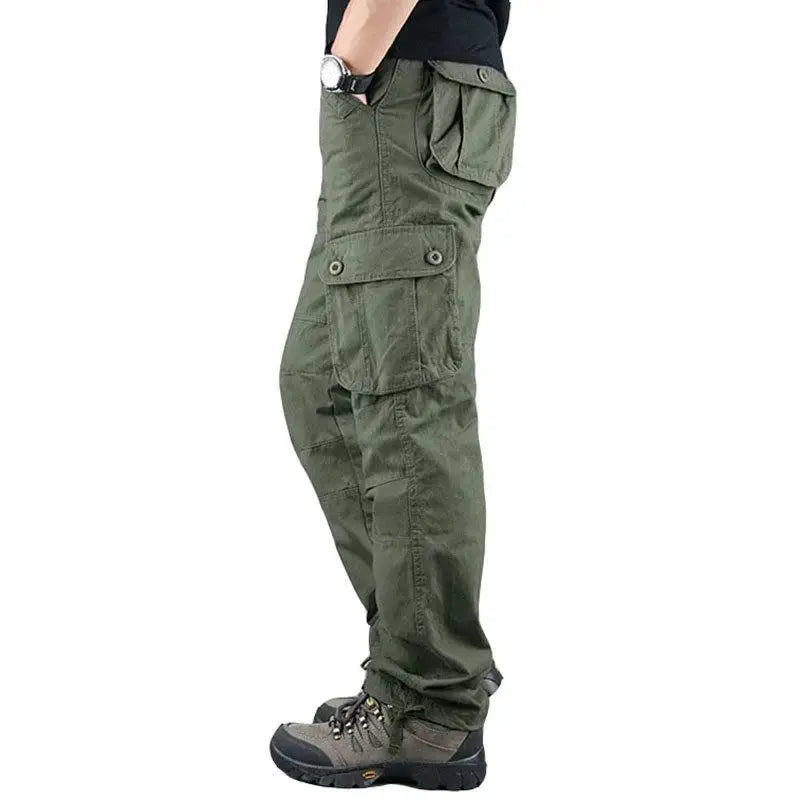 Tactical cargo pants for men, olive green cotton hiking trousers with large buttoned cargo pockets.
