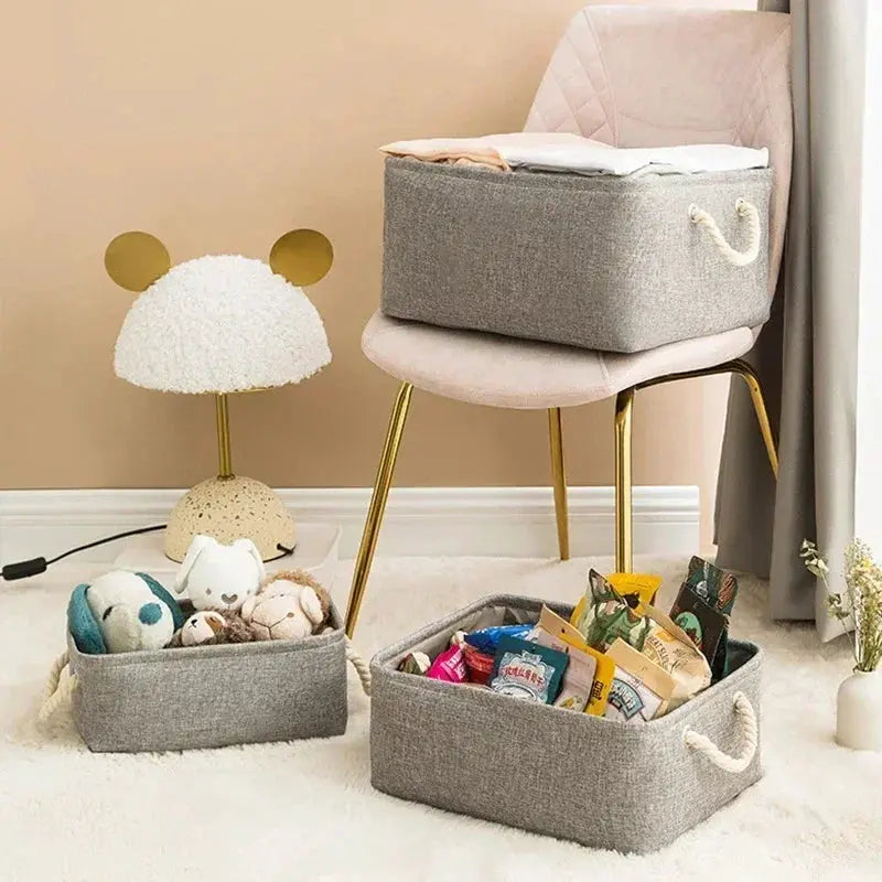 Set of three gray linen storage baskets with rope handles for organizing toys and sundries