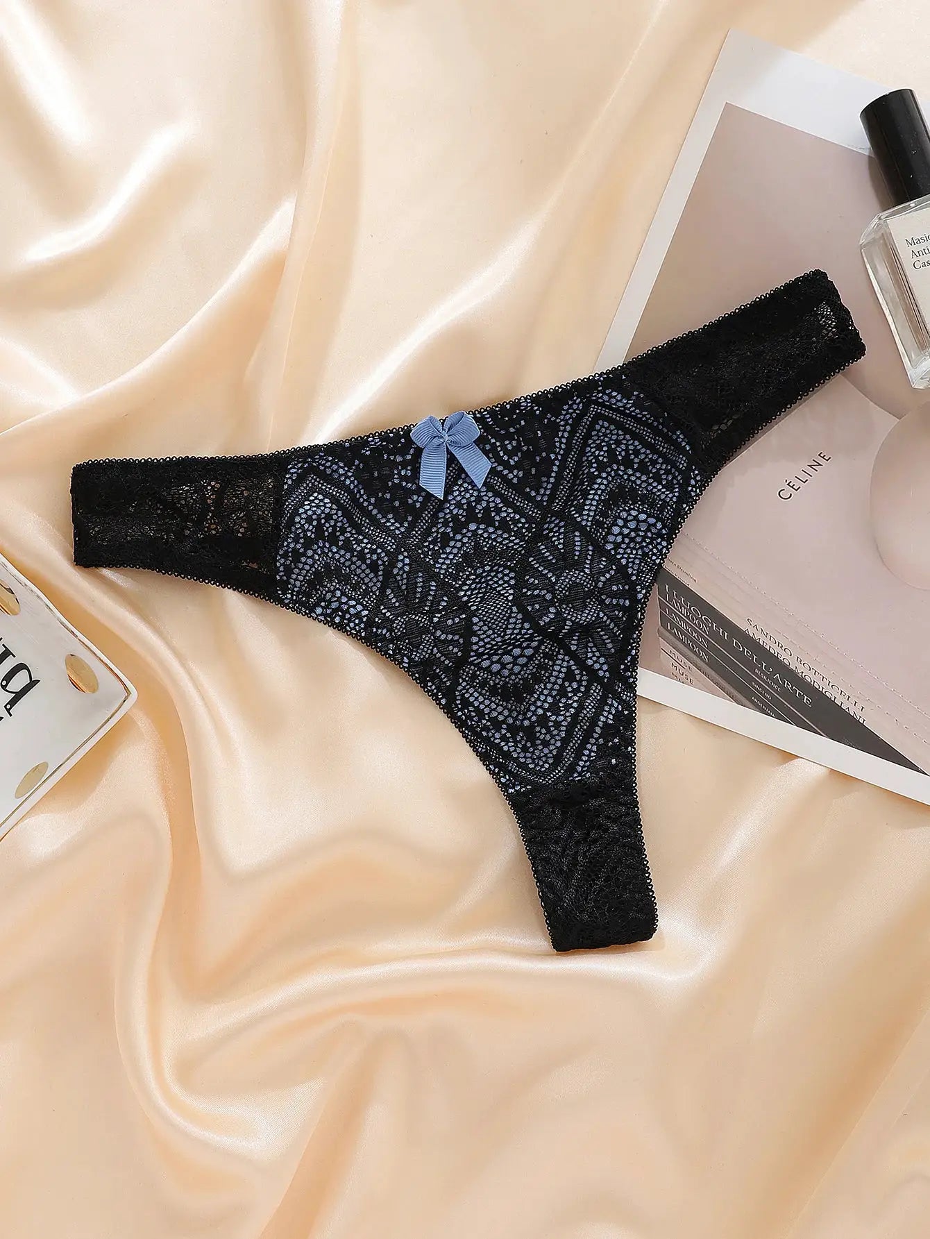 G-string panty in black lace with blue bow, transparent panels, mid-low rise underwear