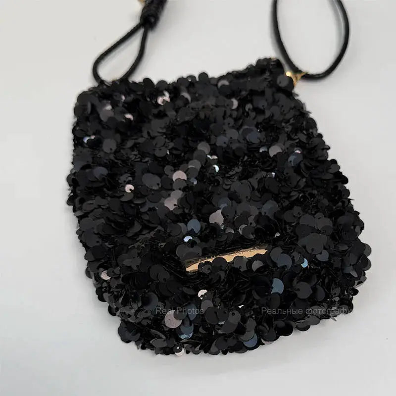 Mini sequin shoulder bag in black with crossbody strap and gold hardware