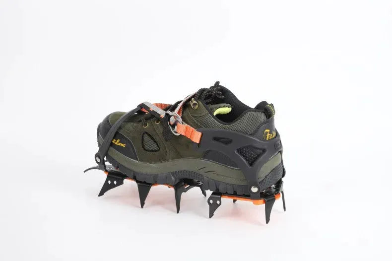 12-tooth ice crampons for shoes by Simples Market with orange straps on an olive hiking boot and metal spikes