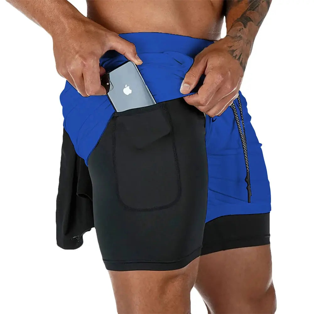 Men's 2-in-1 quick-dry fitness shorts, blue with black liner, side pocket holding a smartphone
