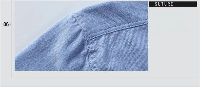 Blue denim shirt shoulder close-up with SUTURE logo