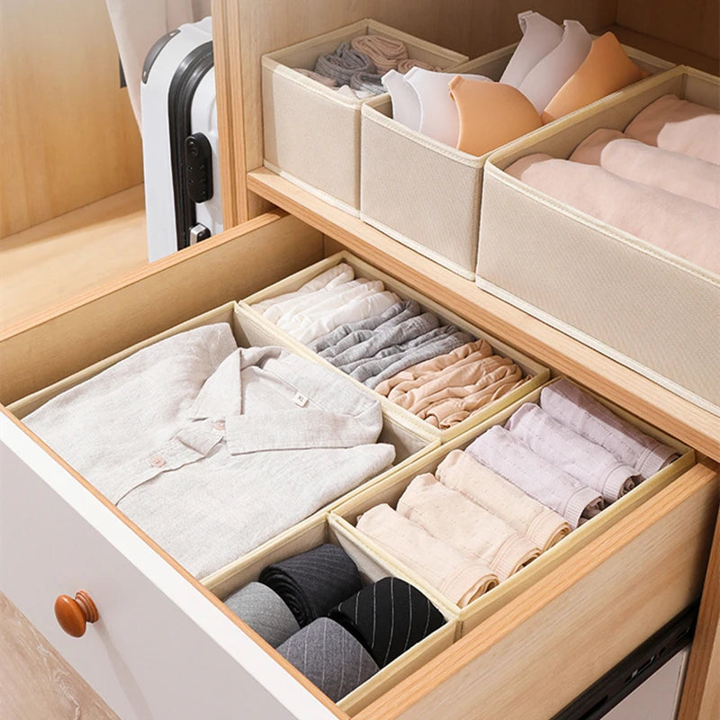 Foldable drawer organizer set by Simples Market in beige fabric, with compartments for shirts and socks in a wardrobe
