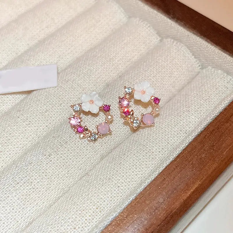 Colorful flower earrings with imitation pearl accents and geometric stud design