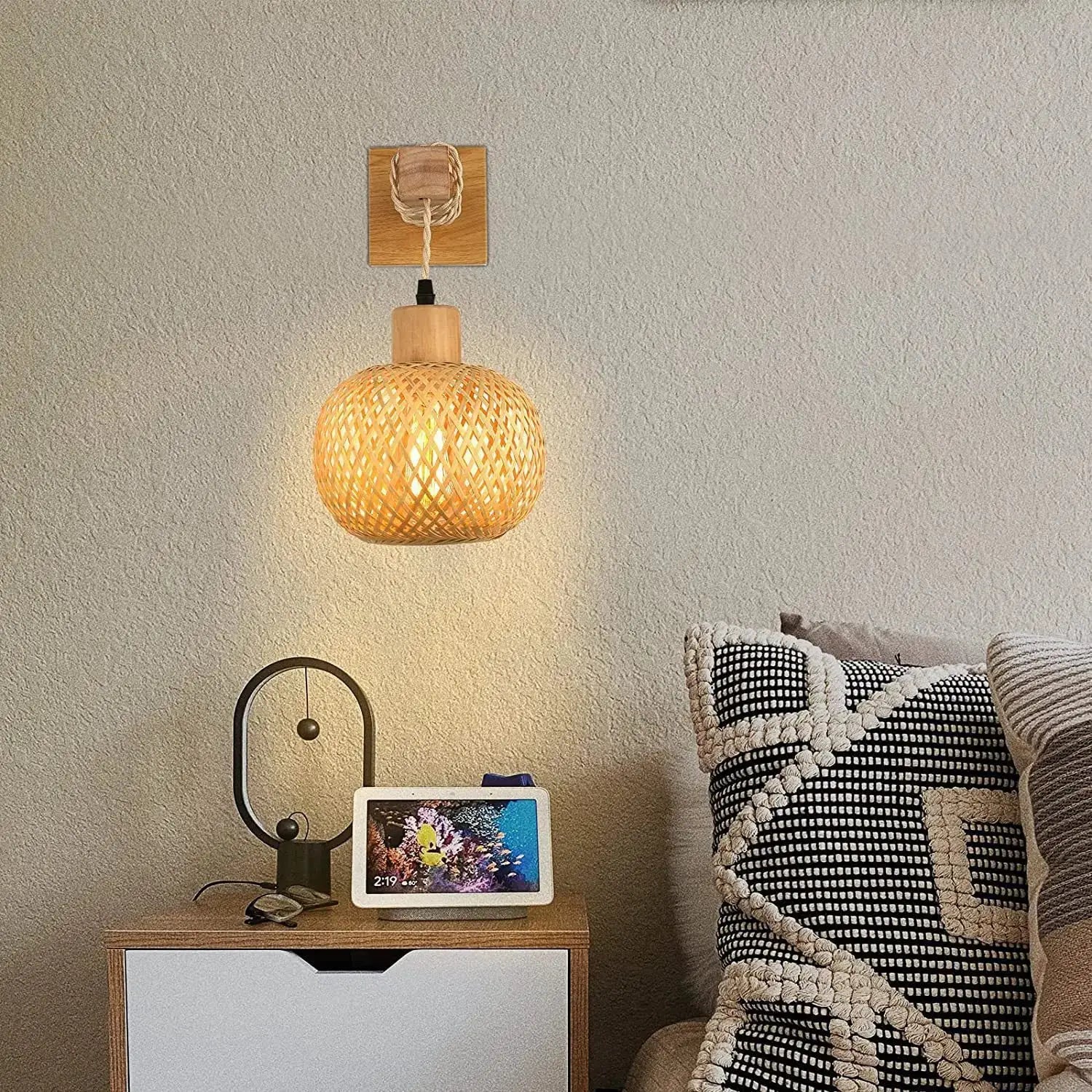 Bamboo lantern wall lamp with hand-woven natural rattan wicker, round lattice shade mounted on a wooden backplate