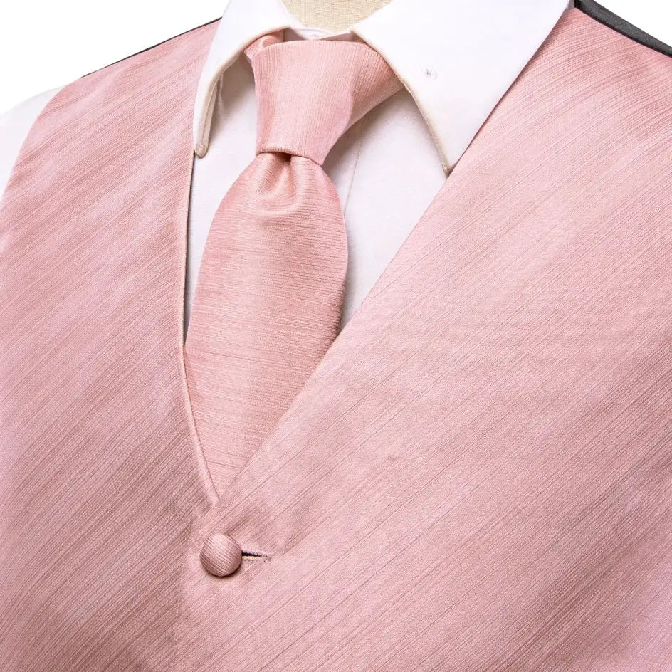 Pink textured men's waistcoat and matching tie set on a white shirt