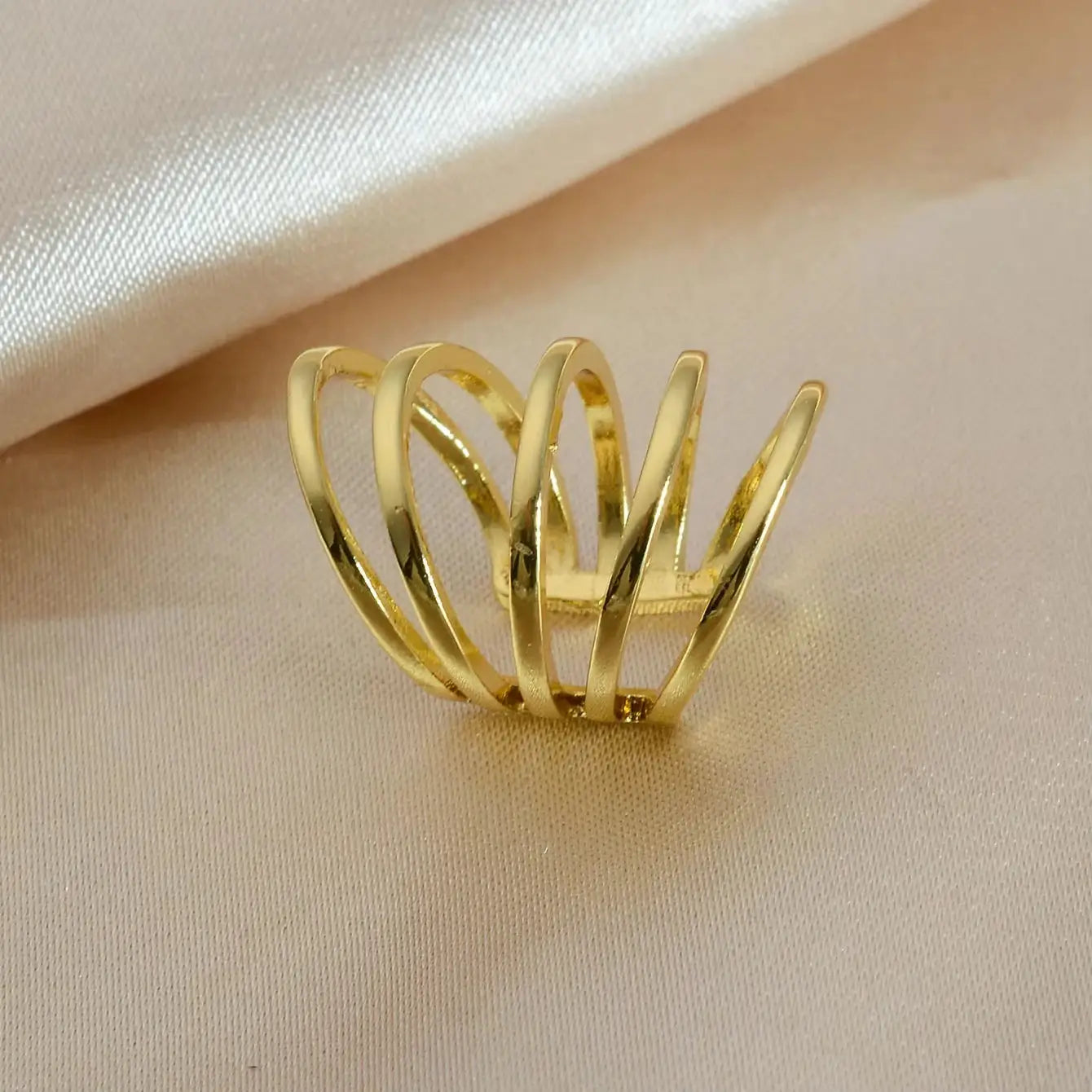 Gold-tone clip-on heart ear cuff with layered spiral bands by Simples Market