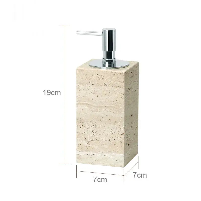 Beige travertine soap dispenser on a rectangular travertine vanity block with chrome pump