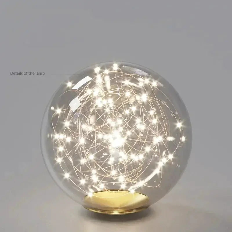 Nordic ceiling chandelier orb lamp by Simples Market with glass globe and warm LED lights, gold base.