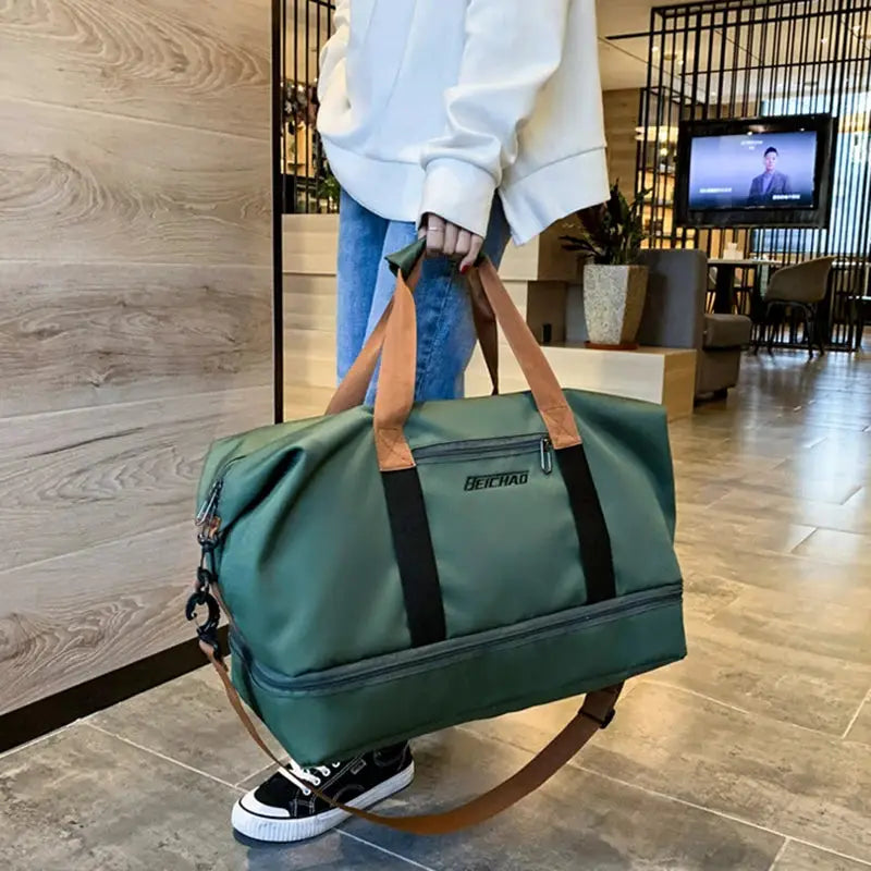 Expandable travel duffle bag by Simples Market, green with tan handles and black straps; Heichao logo.