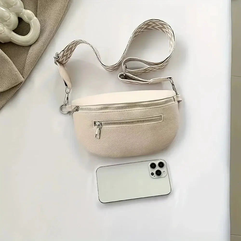 Beige soft leather fanny pack with front zip pocket and chevron-pattern crossbody strap