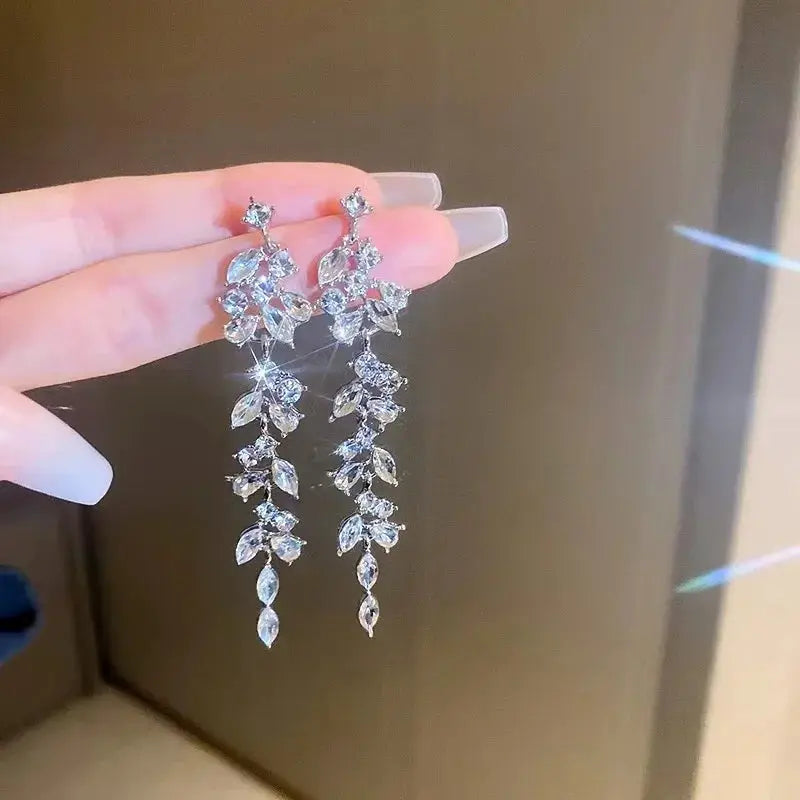 Punk geometric zinc alloy dangling earrings with crystal leaf motifs, silver-tone pair.