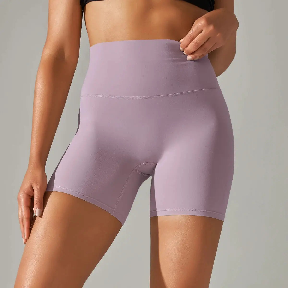 Women's lavender high-waisted yoga shorts with a tight athletic fit