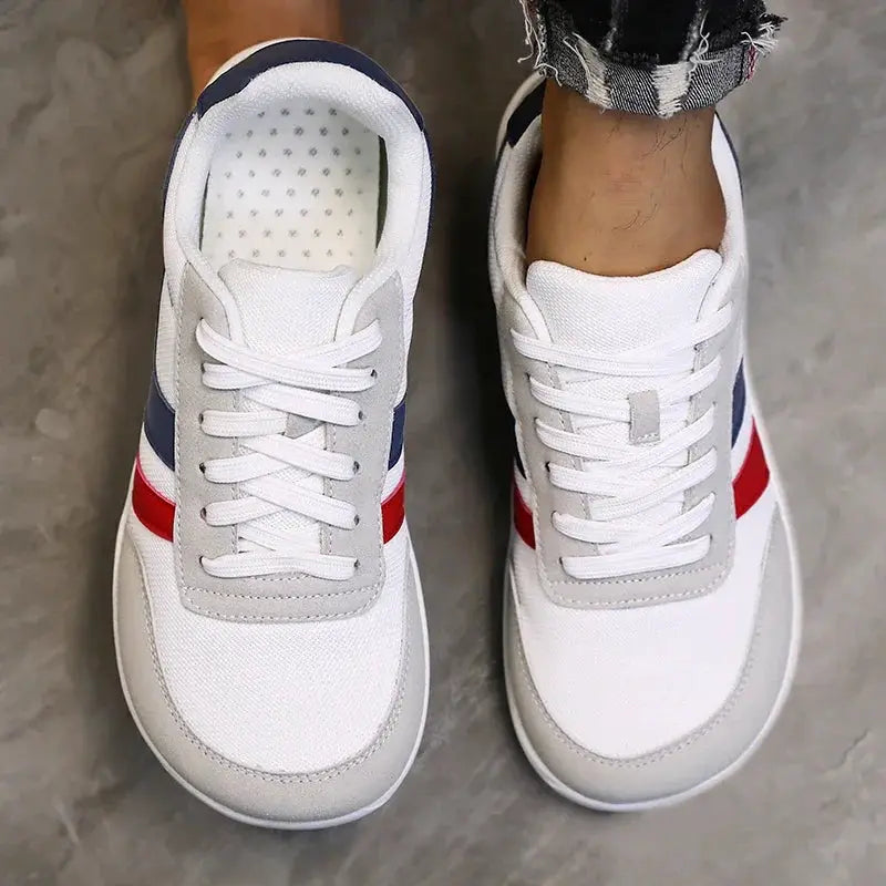 Pair of wide running shoes by Simples Market, anti-slip, lightweight, breathable mesh; overlays and red/blue stripes.