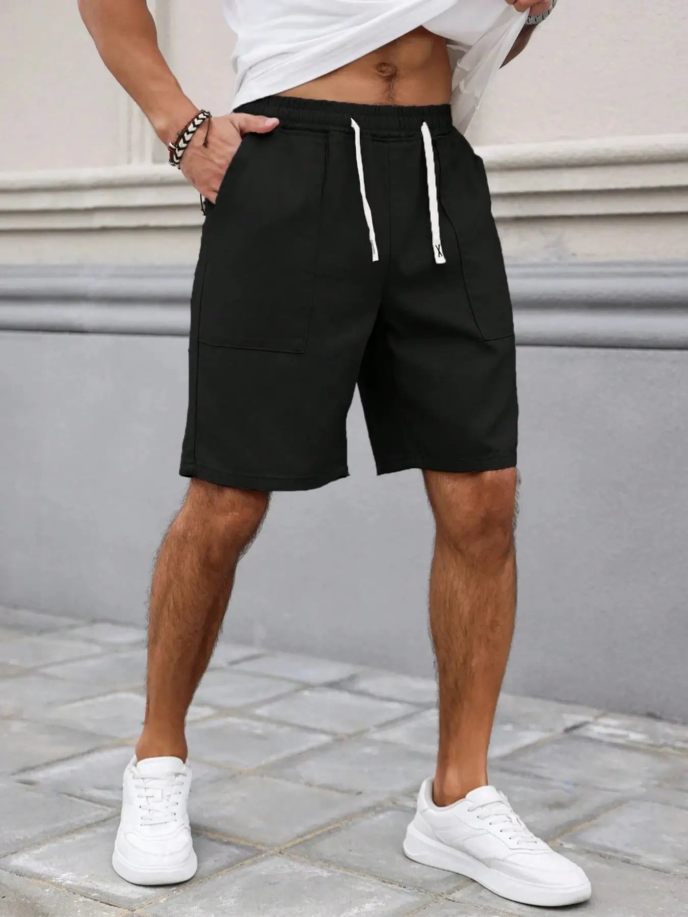 Men's black drawstring shorts, mid-length casual style with front pockets