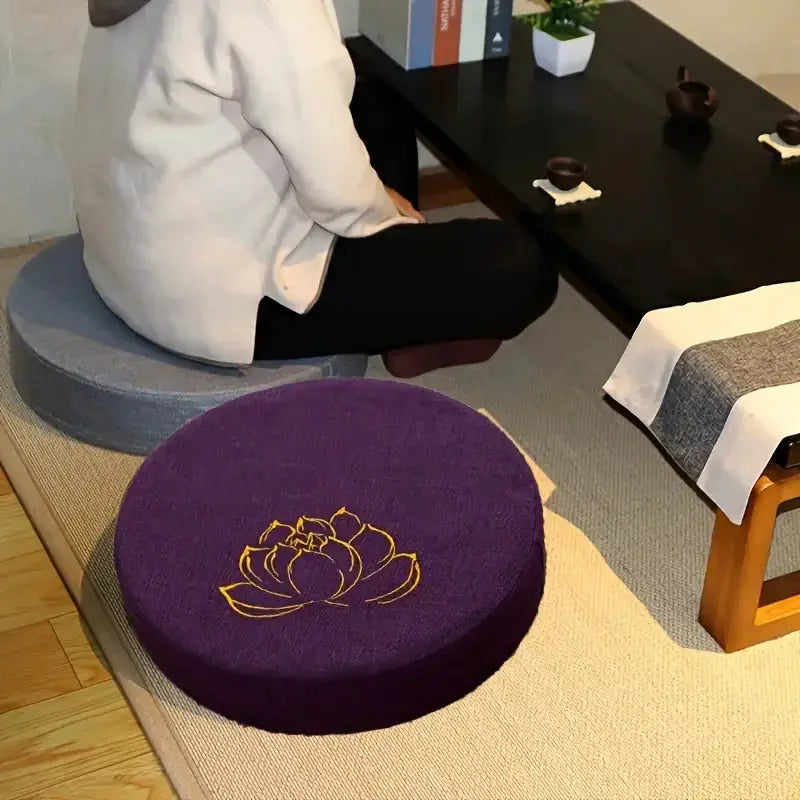 Purple lotus-embroidered round meditation cushion, 40×6 cm, linen cover, removable and washable; Simples Market.