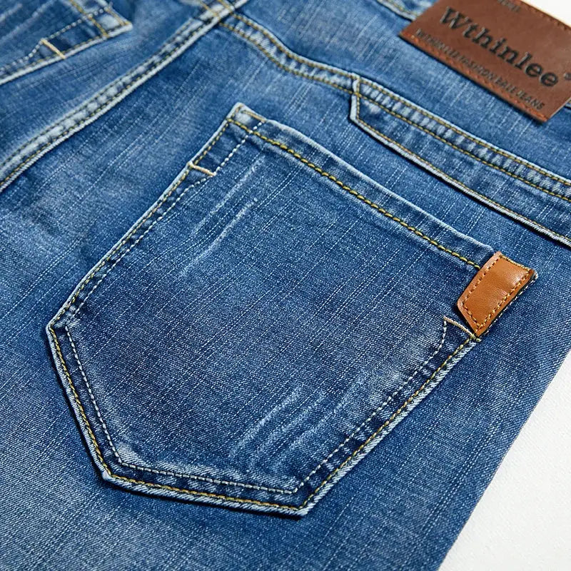 Men's slim blue denim shorts with back pocket and brown leather patch detail
