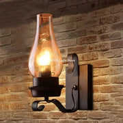 Wall sconce lamp in black wrought iron with a clear glass shade, industrial loft style