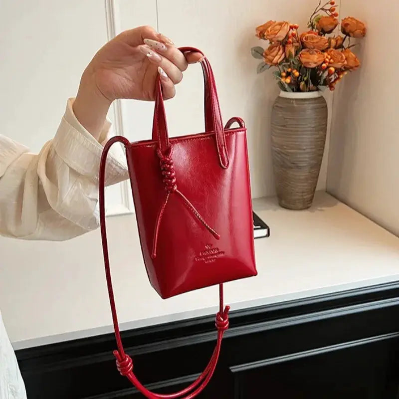 PU leather mini crossbody bag in red by Simples Market with long strap and knotted cord accents