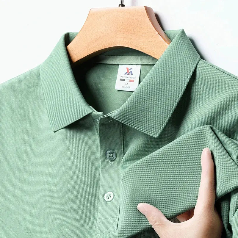 Men's green polo shirt, short sleeves with collar and button placket, textured fabric on a wooden hanger close-up
