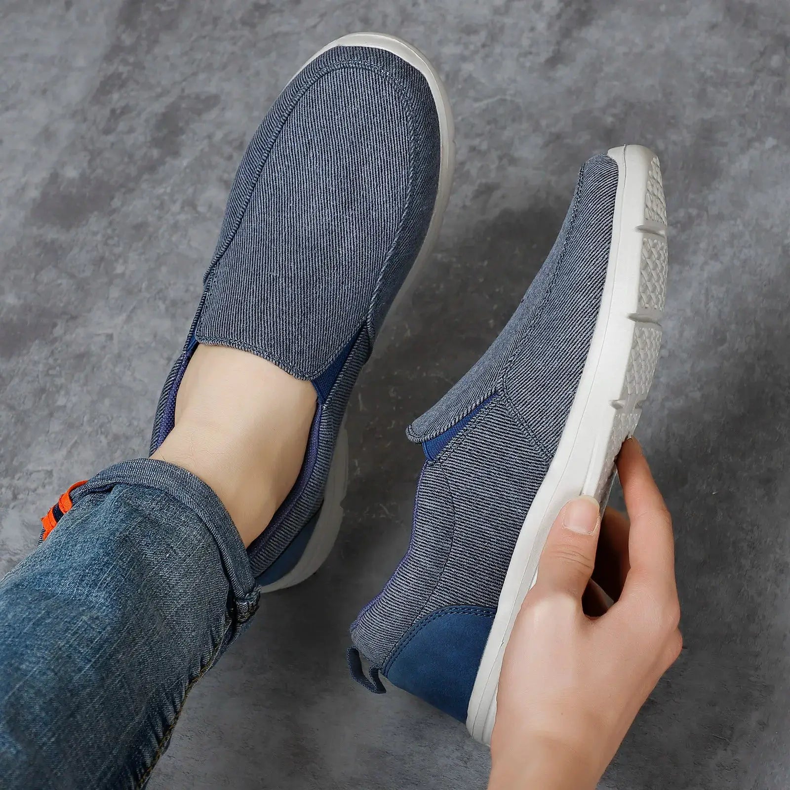 Men's blue denim canvas slip-on sneakers pair with breathable design and white sole