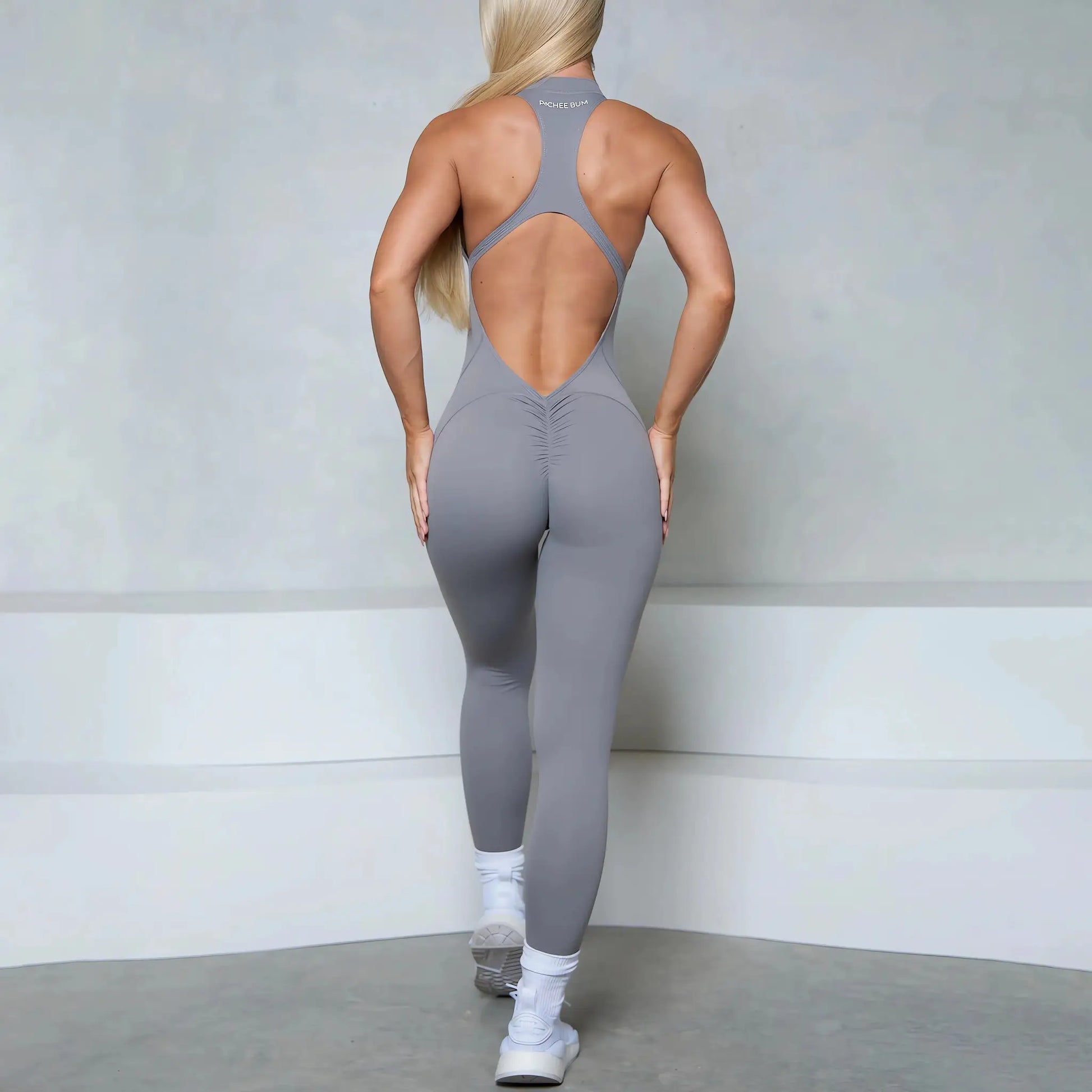 Women gray sleeveless jumpsuit with back cutout, racerback zipper, scrunch butt, Simples Market gym wear.