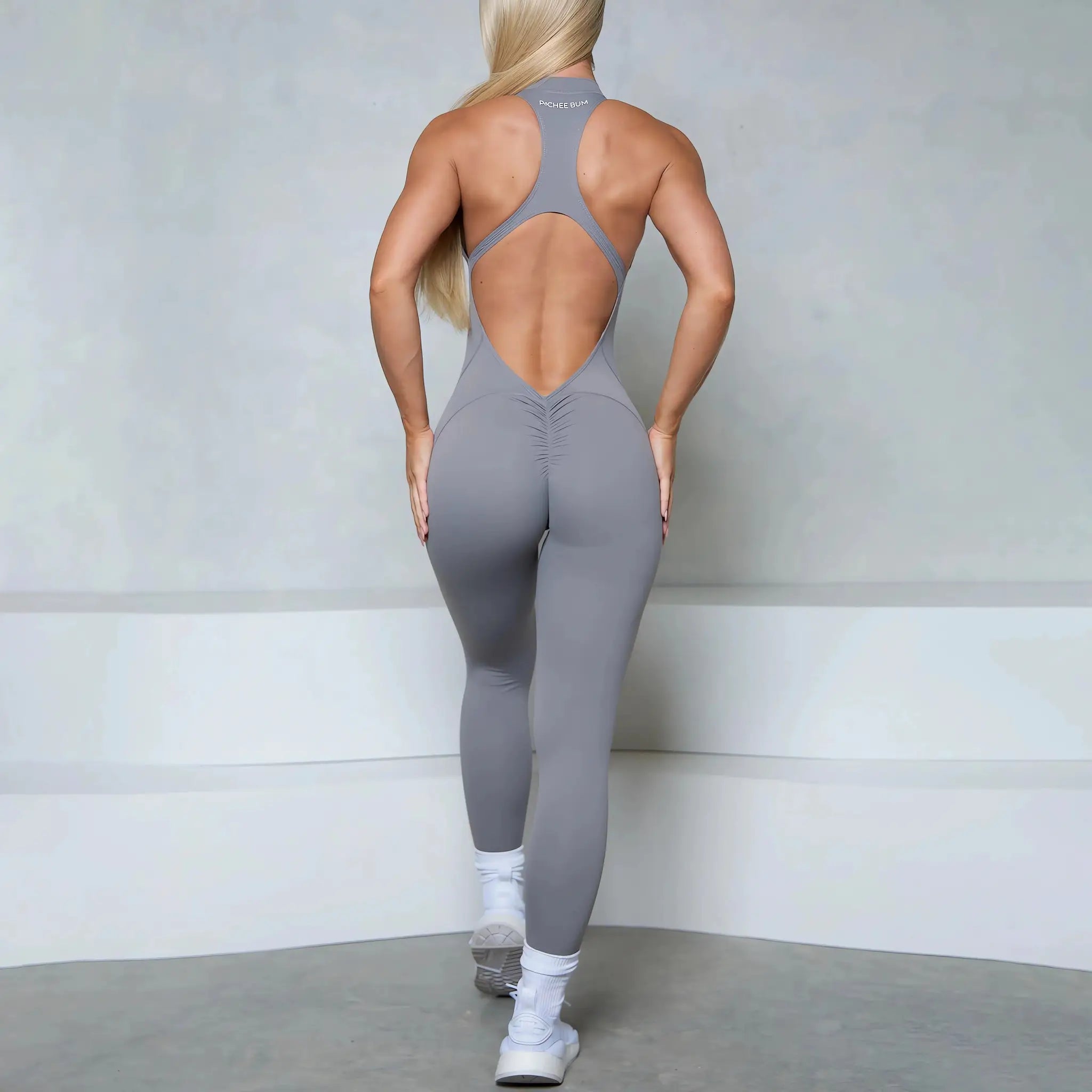 Women gray sleeveless jumpsuit with back cutout, racerback zipper, scrunch butt, Simples Market gym wear.
