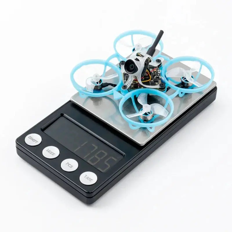 BETAFPV Air65 ll brushless whoop quadcopter on a digital scale with light blue prop guards