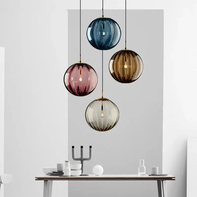 Simples Market modern LED glass ball pendant light set with four blue, pink, amber and clear pendants over dining table