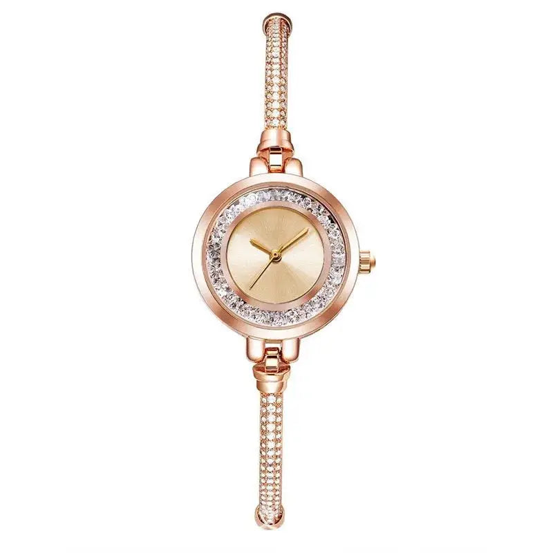 Women's gold-tone wristwatch with crystal-embellished bezel and bracelet; quartz movement