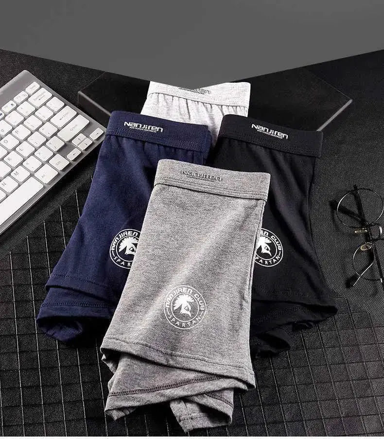 Plus size men's cotton boxer shorts in gray, navy, and black; three folded pairs.