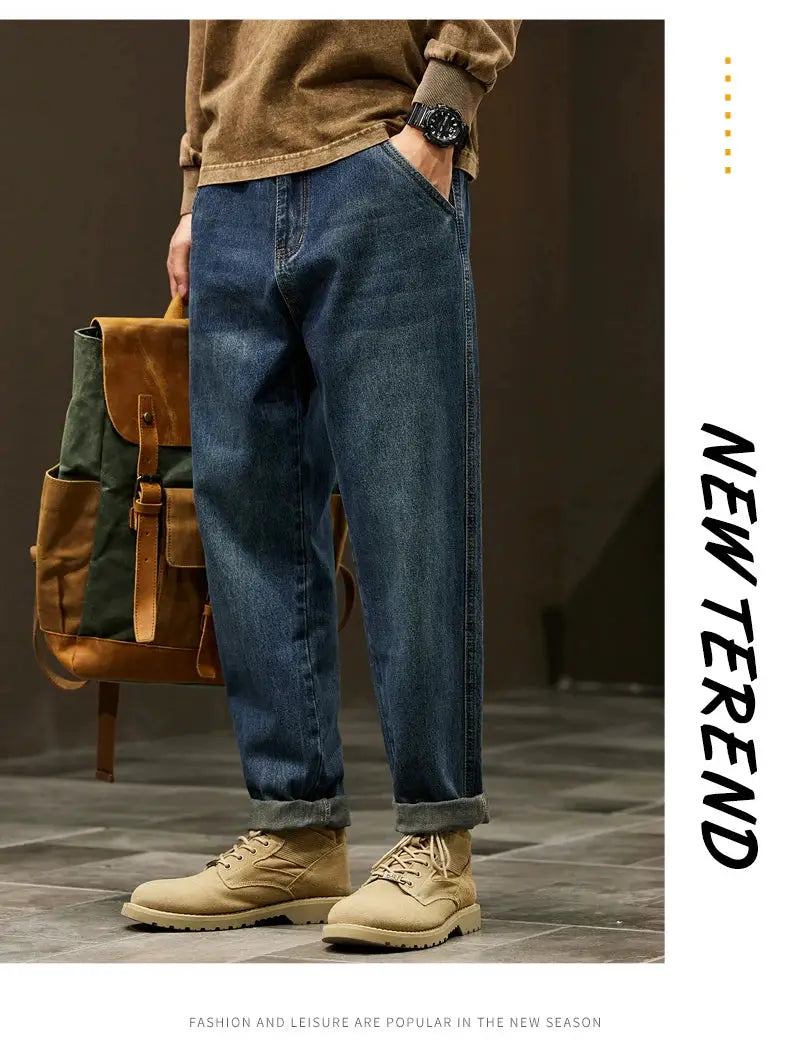Men's loose-fit denim jeans in blue with rolled cuffs for a baggy casual outdoor look