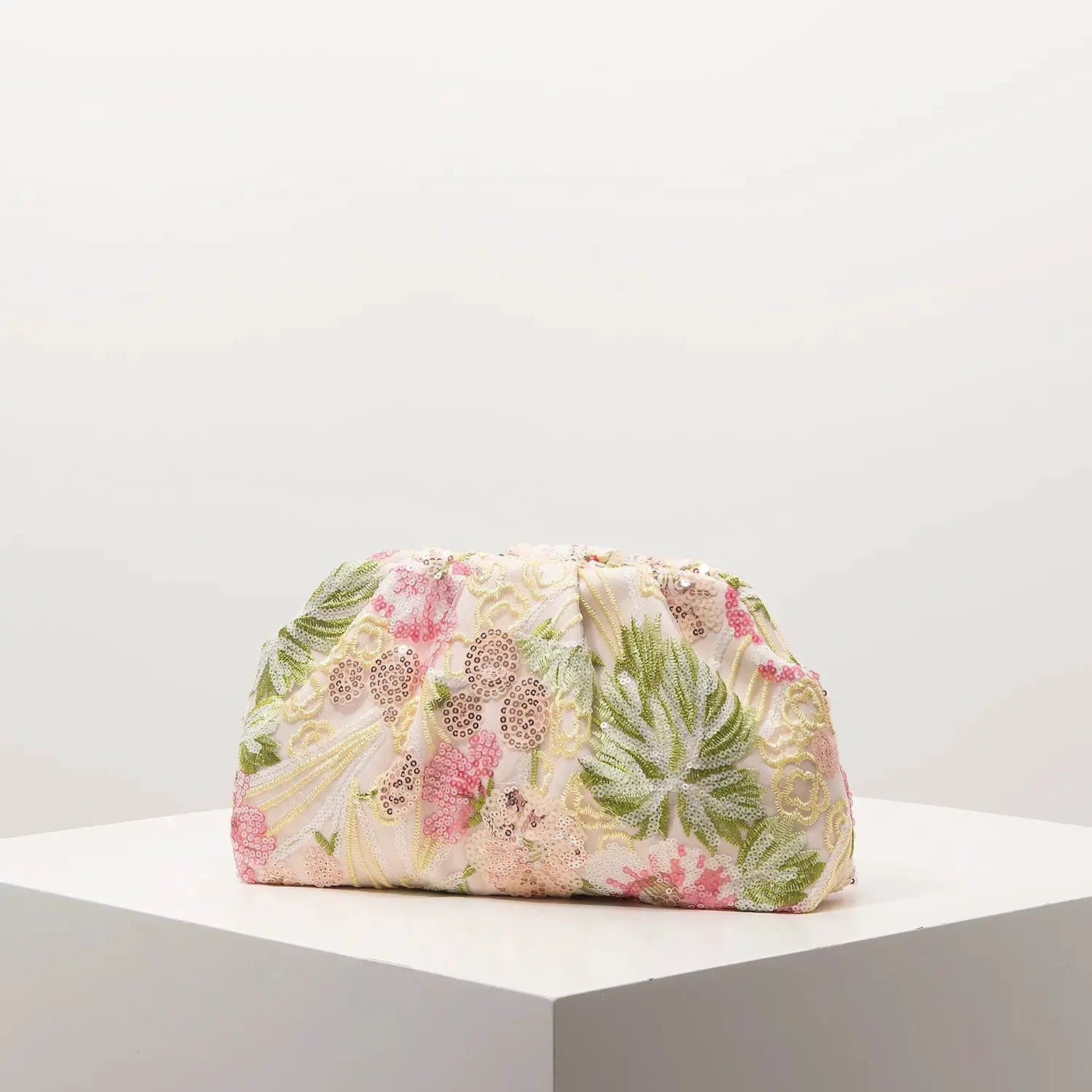 Clutch bag with pastel pink floral sequin embroidery on pale fabric
