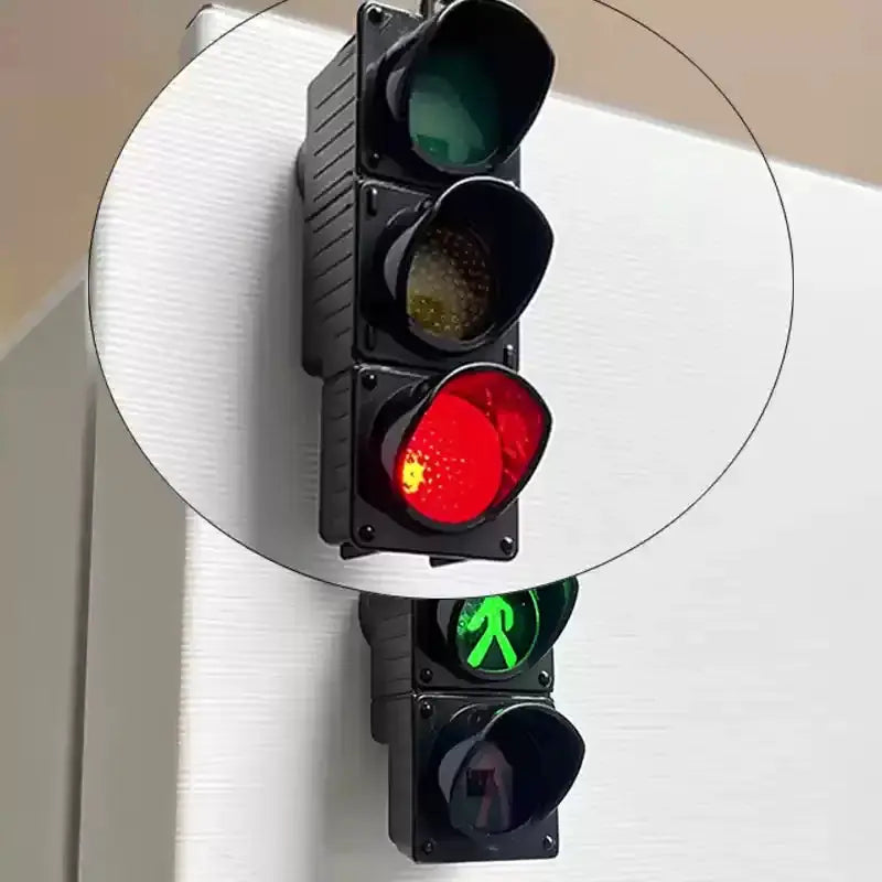 Traffic light magnets, two black units with red, yellow, and green lamps and a pedestrian signal for fridge decoration.