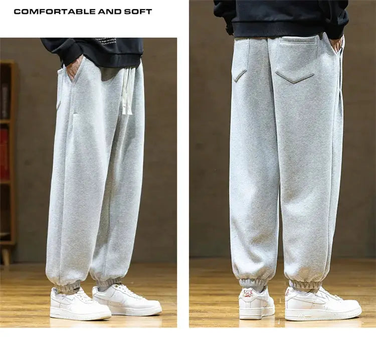 Men's gray jogger sweatpants with drawstring, loose fit, elastic cuffs, and rear pockets