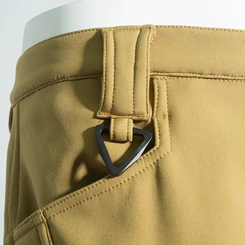 Men's khaki cargo hiking pants with belt loops and a black triangular buckle, ideal for trekking and outdoor wear.