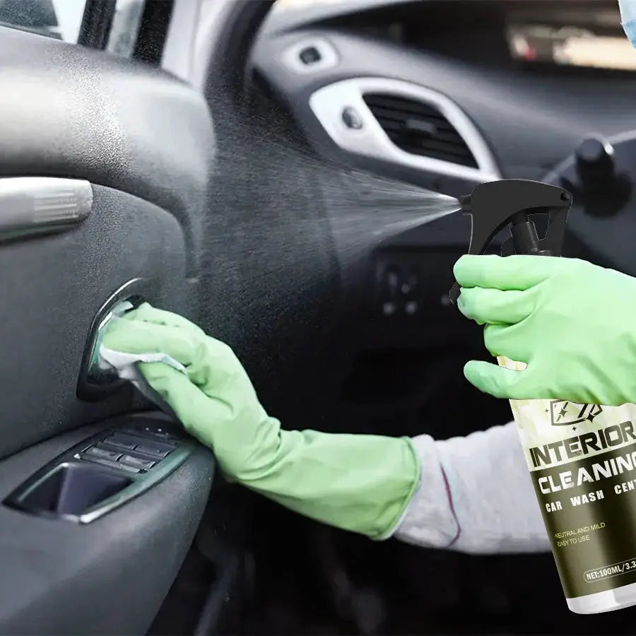 Ryekew Car interior cleaner spray bottle used inside car with green gloves cleaning dashboard.