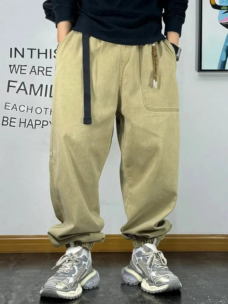 Baggy cargo pants in beige by Simples Market with elastic cuffs and front pockets