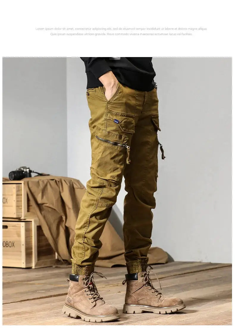 CAAYU men's cargo jogger pants with multiple pockets and zipper details in olive-brown, paired with tan boots