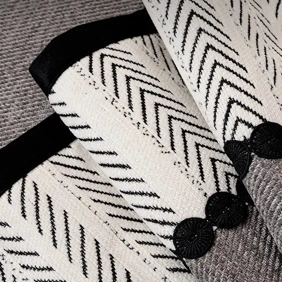 Sofa cover in ivory twill chenille with black chevron pattern and tassel trim